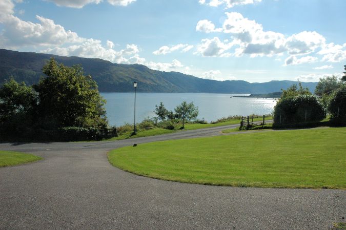 Tarlogie has a spacious open-plan garden from which there are superb views across Loch Carron to the mountains to the south.